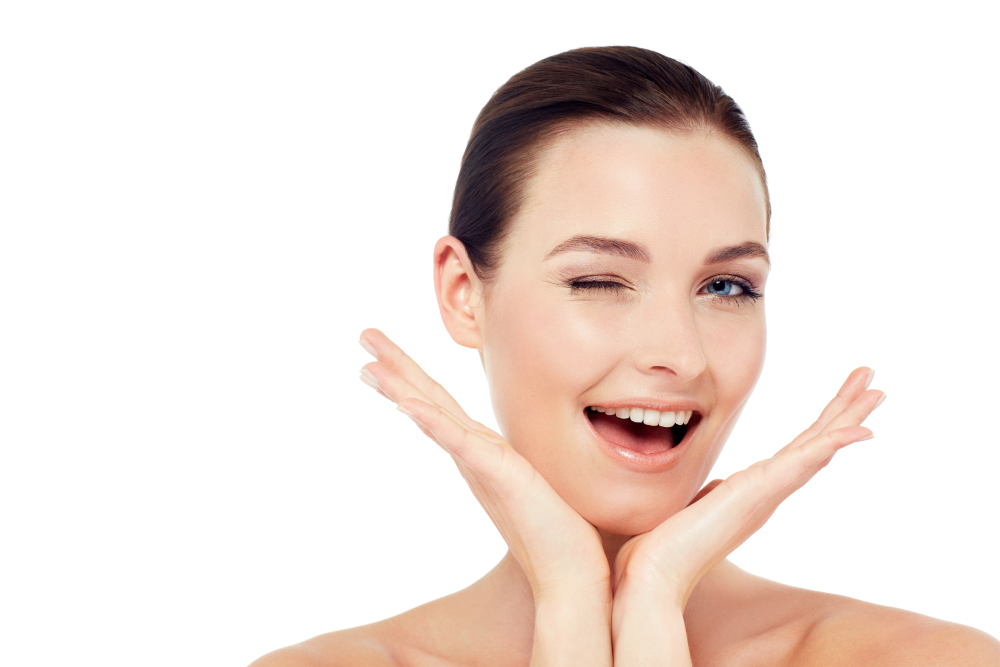 Woman with glowing skin smiling after microneedling.